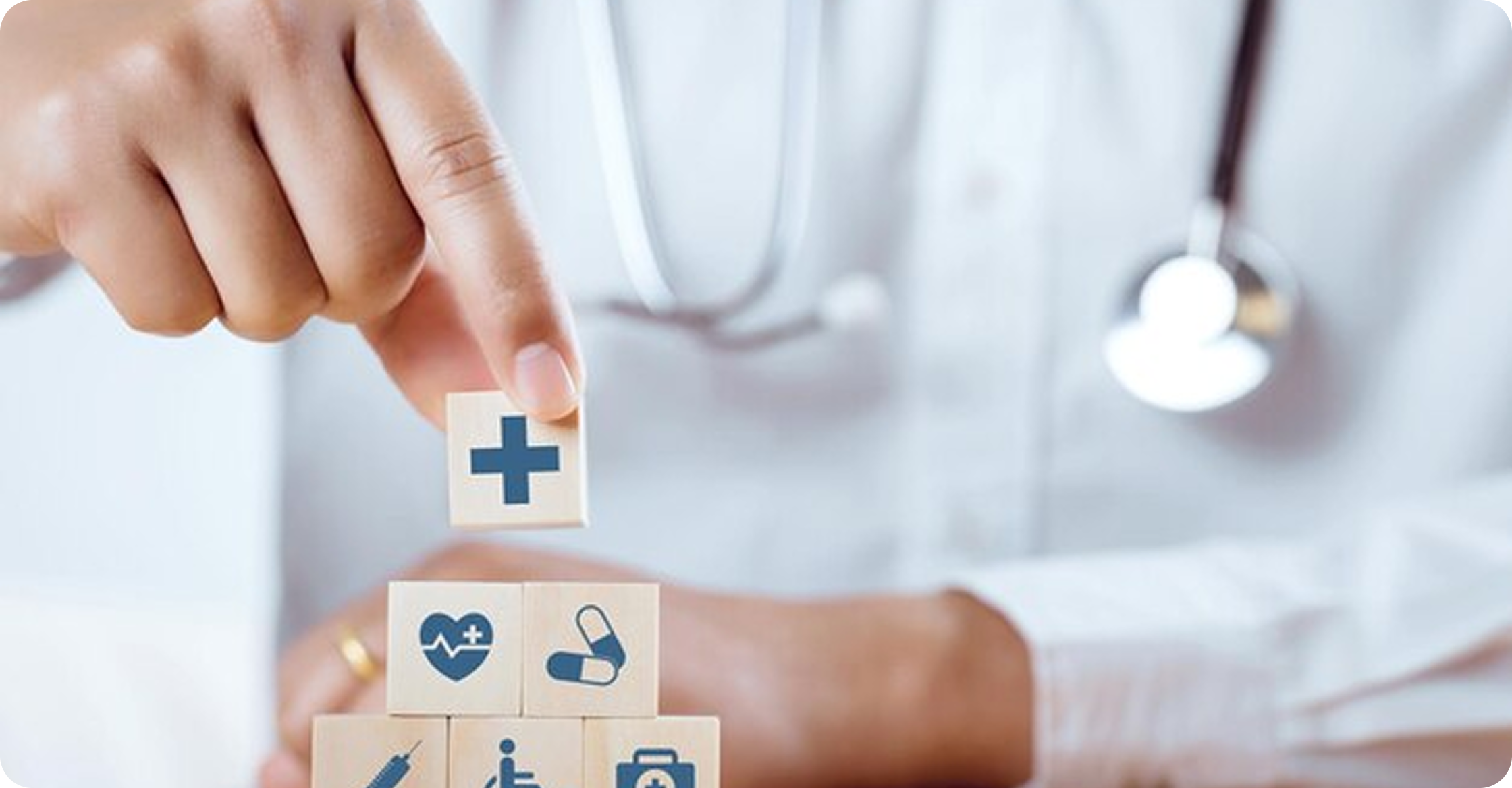 Doctor stacking healthcare symbol blocks