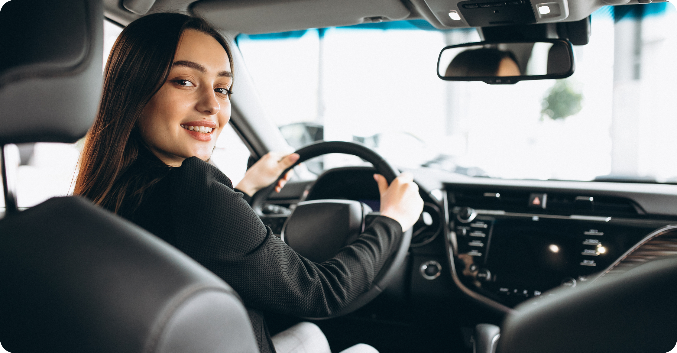 Passenger smiling from the driver seat of a car